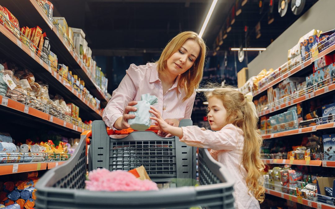 mom and daughter pushing shopping cart grocery store