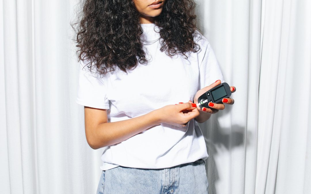 woman testing blood sugar glucose strip