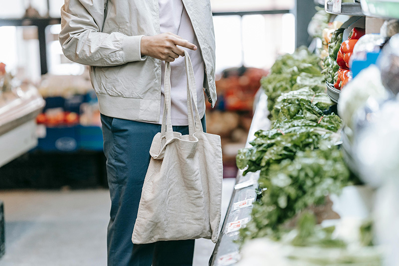 man choosing produce at a supermarket
